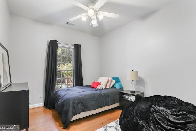 bedroom with ceiling fan and light hardwood / wood-style flooring