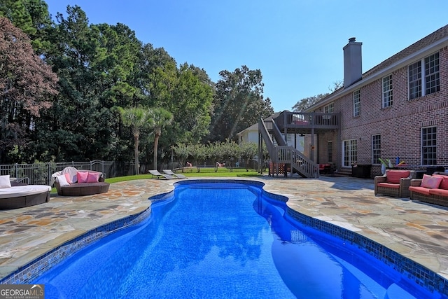 view of pool with an outdoor hangout area, a deck, and a patio area