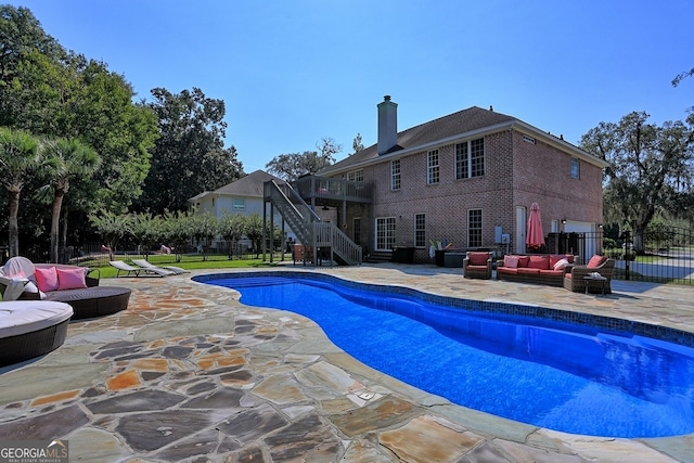 view of pool with a patio and an outdoor living space