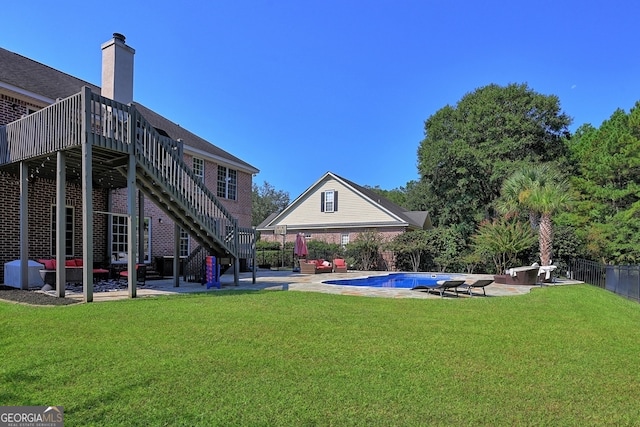 view of yard featuring a pool side deck and a patio