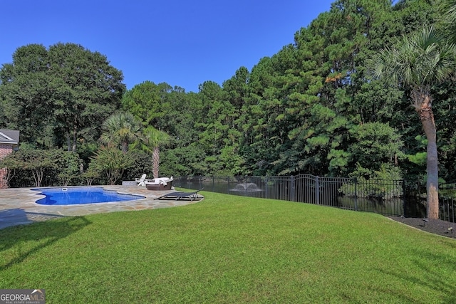 view of yard featuring a fenced in pool and a patio