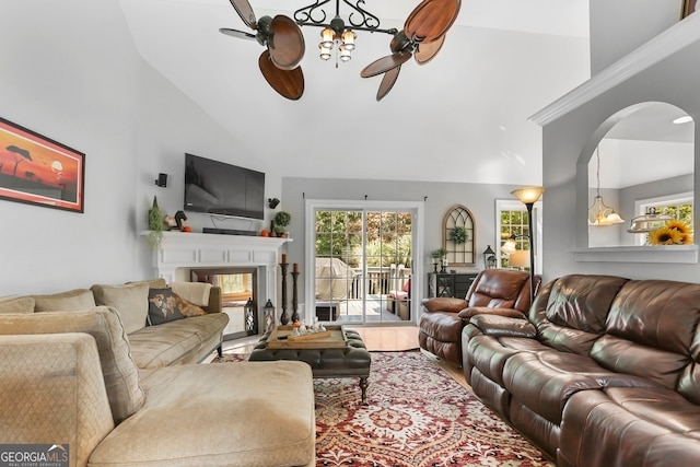 living room featuring wood-type flooring, high vaulted ceiling, and ceiling fan