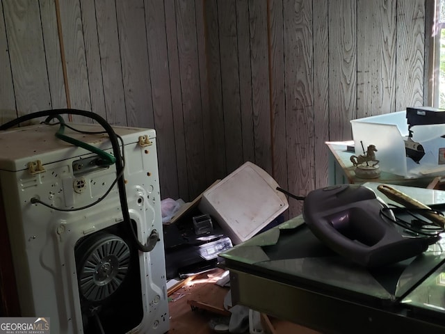 misc room with washer / clothes dryer and wooden walls