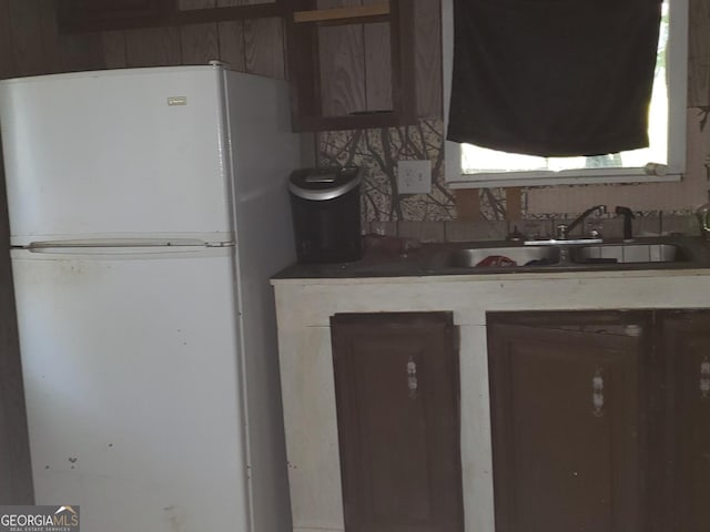 kitchen featuring sink and white fridge