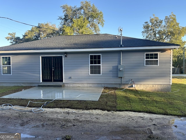 back of property with a patio and a yard