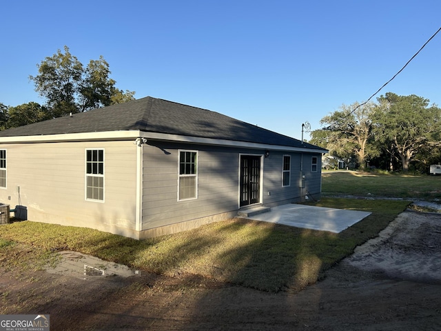 back of property featuring a yard and a patio area