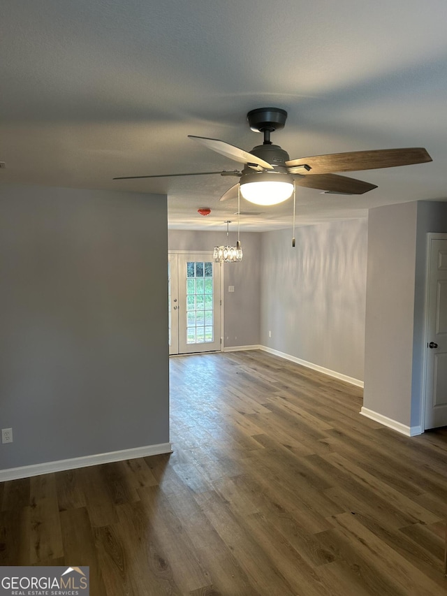 empty room with ceiling fan and dark hardwood / wood-style floors