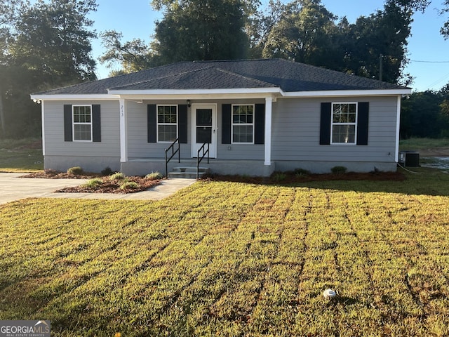 single story home featuring a front lawn, covered porch, and central AC