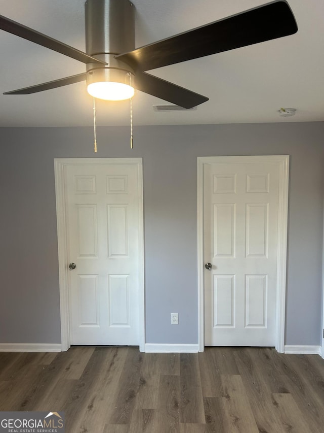 unfurnished bedroom featuring ceiling fan and hardwood / wood-style floors