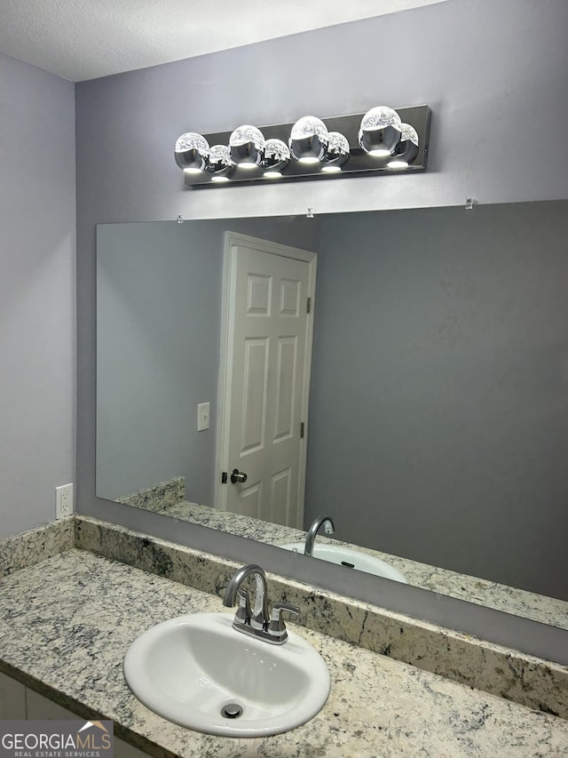 bathroom featuring vanity and a textured ceiling