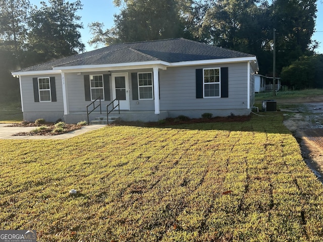 ranch-style home featuring a front yard, a porch, and central AC