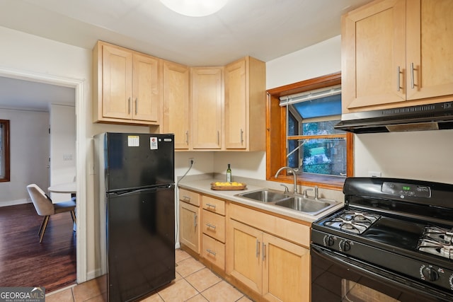 kitchen featuring black appliances, light brown cabinets, and light tile patterned flooring