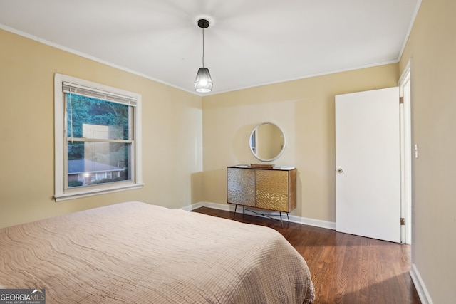 bedroom featuring ornamental molding and dark hardwood / wood-style floors