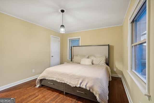 bedroom featuring ornamental molding and dark hardwood / wood-style flooring