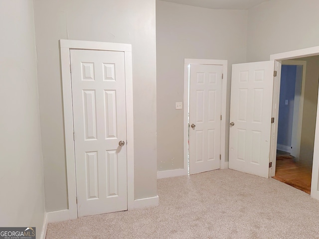 unfurnished bedroom with light colored carpet