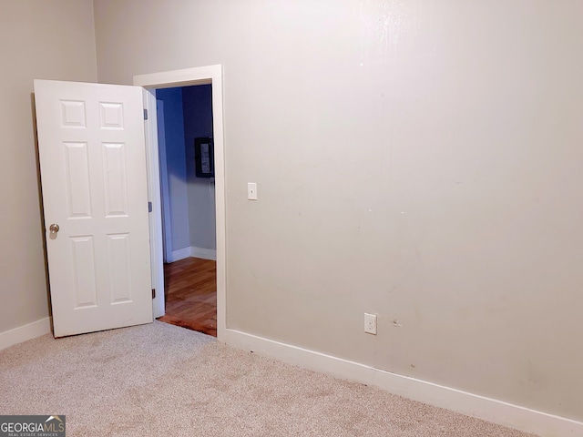 unfurnished room with light carpet