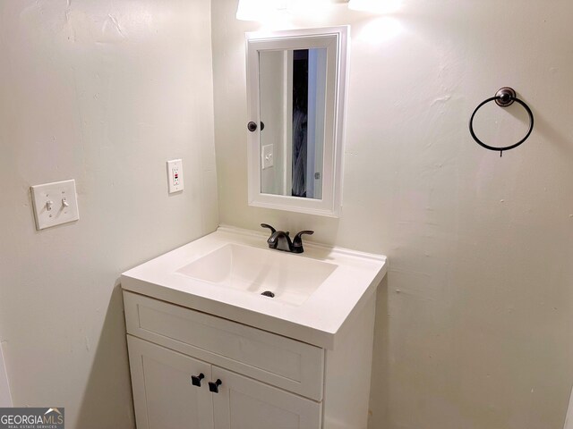 laundry room with light wood-type flooring and stacked washer and dryer