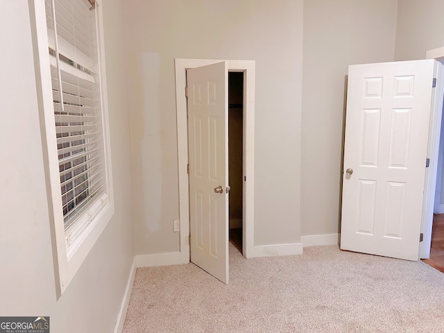 unfurnished bedroom with light colored carpet