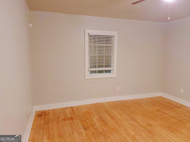 spare room featuring ceiling fan and hardwood / wood-style flooring