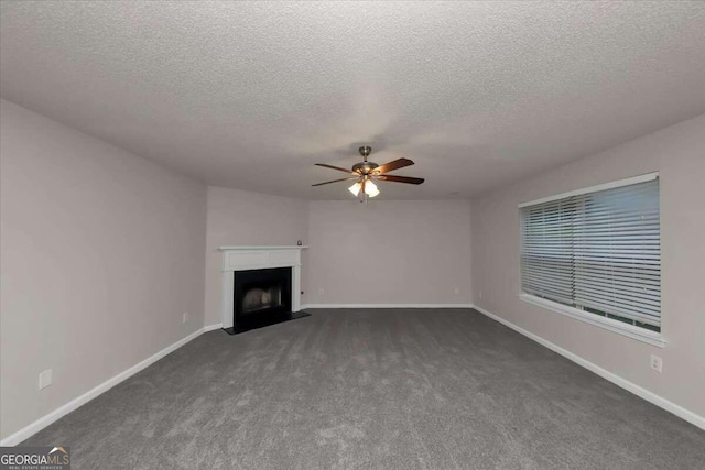 unfurnished living room featuring a textured ceiling, dark colored carpet, and ceiling fan