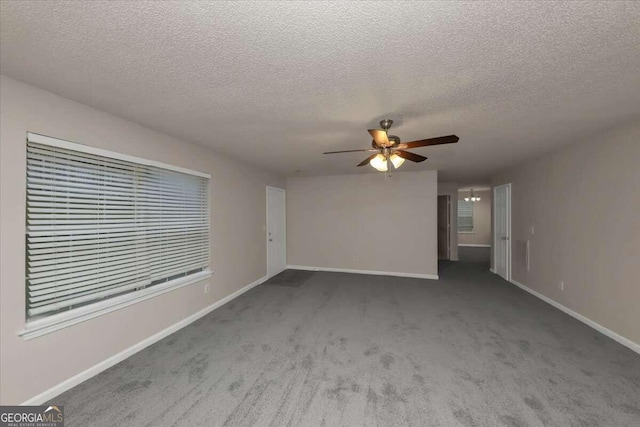 unfurnished living room with a textured ceiling, carpet flooring, and ceiling fan