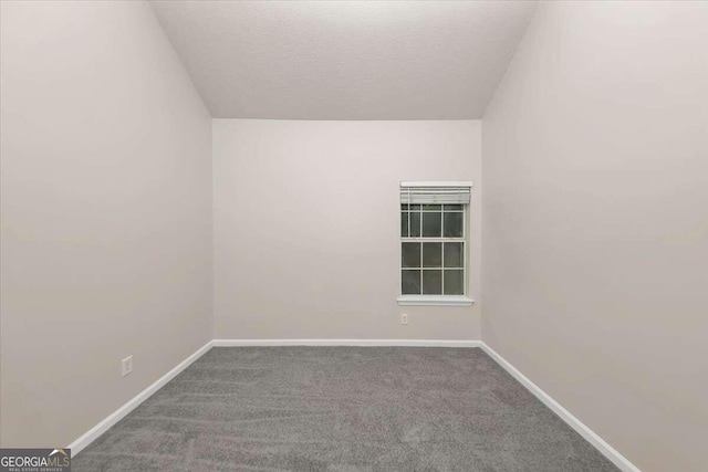 carpeted empty room with a textured ceiling