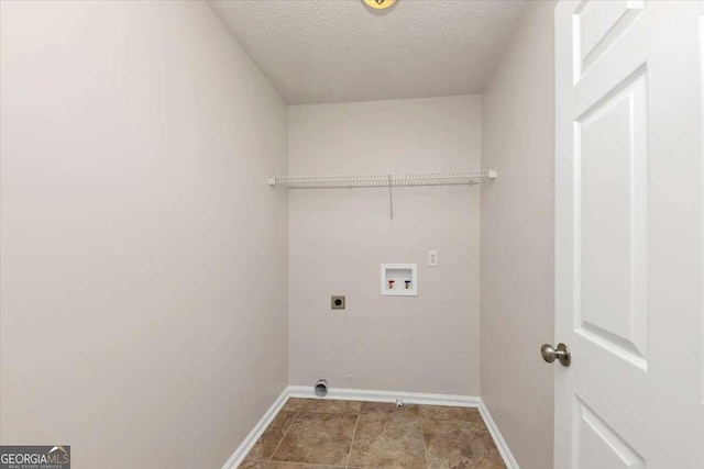 clothes washing area featuring a textured ceiling, electric dryer hookup, and hookup for a washing machine