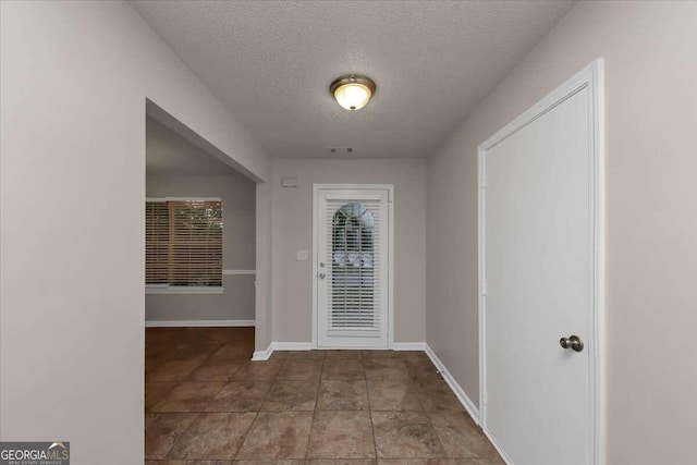 foyer entrance with a textured ceiling