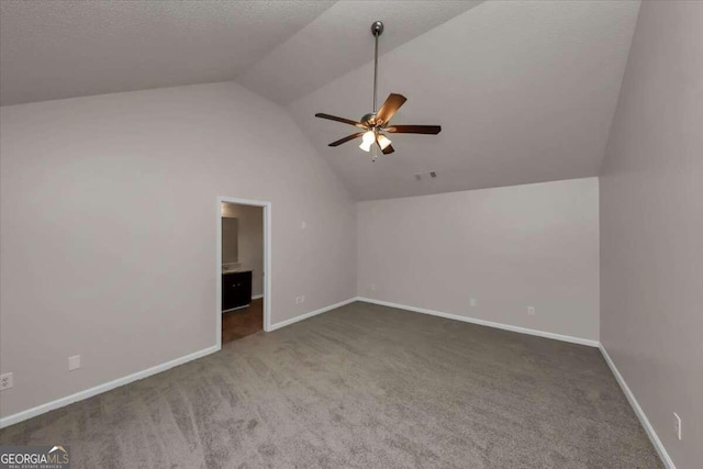 bonus room featuring dark colored carpet, lofted ceiling, and ceiling fan