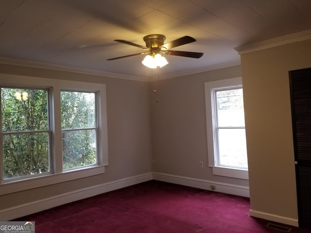 unfurnished room with ceiling fan, plenty of natural light, crown molding, and dark colored carpet