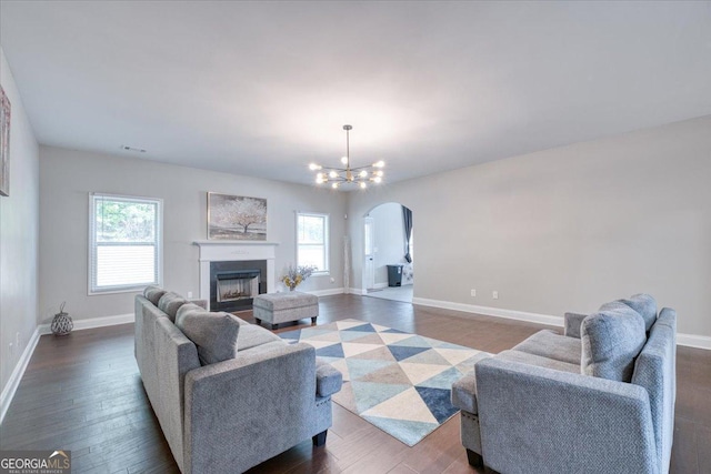 living room featuring dark hardwood / wood-style flooring and a notable chandelier