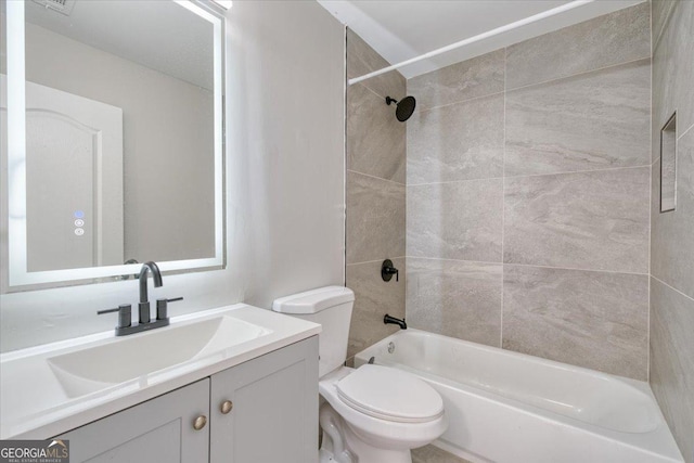 full bathroom with vanity, toilet, and tiled shower / bath