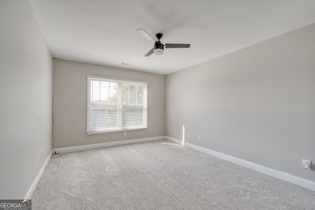 unfurnished room with ceiling fan and light colored carpet