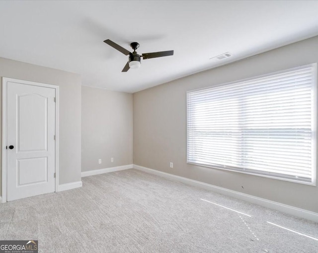 carpeted empty room featuring ceiling fan