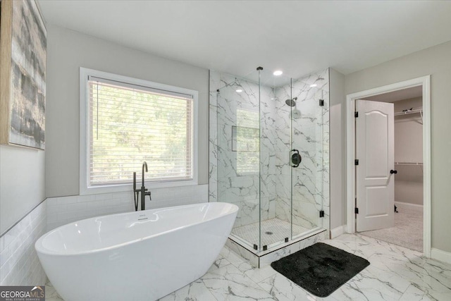 bathroom with independent shower and bath and tile walls