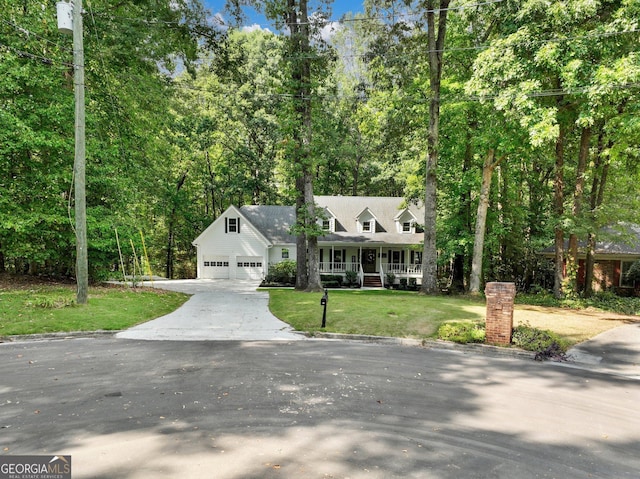 new england style home featuring a front lawn, covered porch, and a garage