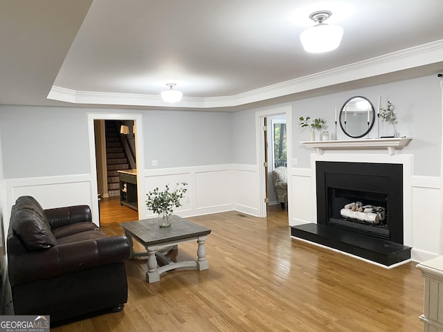 living room featuring hardwood / wood-style floors and ornamental molding