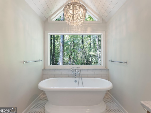 bathroom featuring a bathtub, lofted ceiling, wood ceiling, and an inviting chandelier