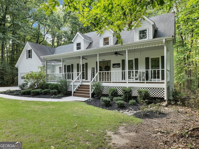 cape cod house with ceiling fan, covered porch, and a front yard