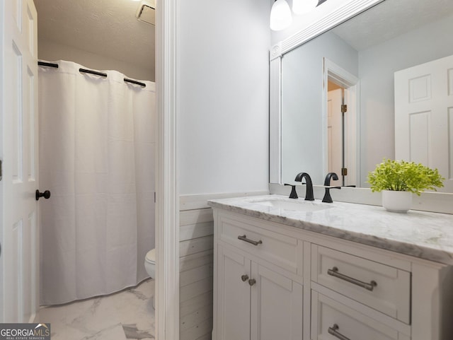 bathroom featuring vanity, toilet, a textured ceiling, and walk in shower