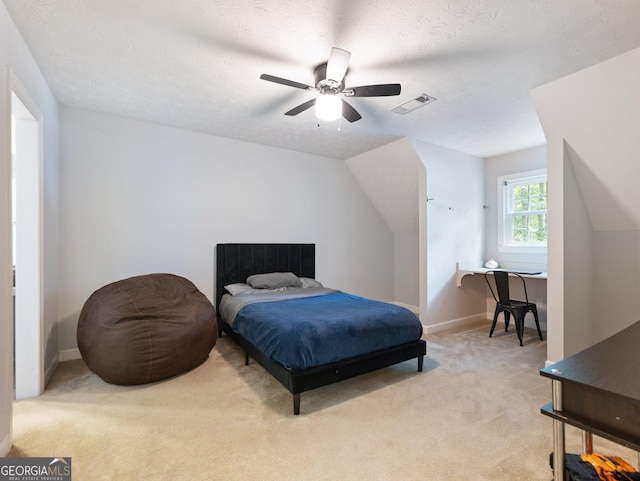 carpeted bedroom featuring a textured ceiling, ceiling fan, and lofted ceiling