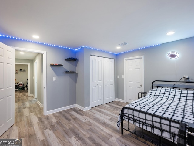 bedroom featuring light hardwood / wood-style flooring and a closet