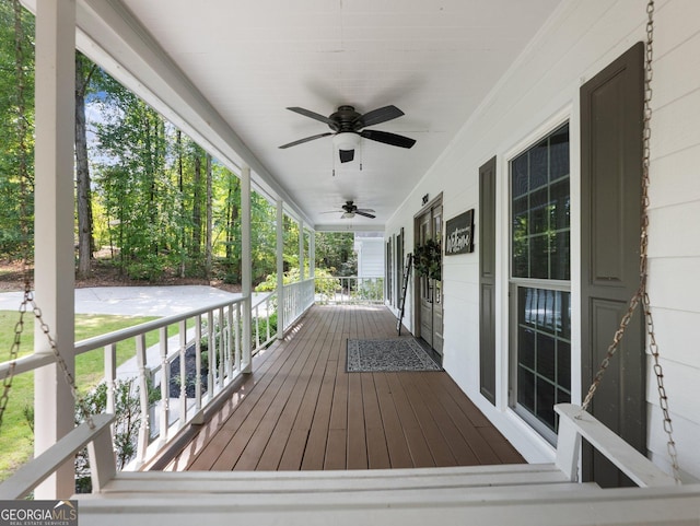 wooden terrace featuring ceiling fan and a porch