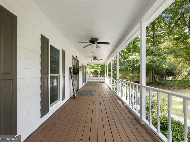 wooden terrace with ceiling fan and a porch