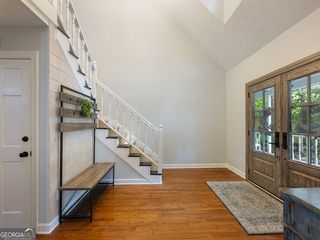 entrance foyer with a textured ceiling, hardwood / wood-style flooring, and lofted ceiling