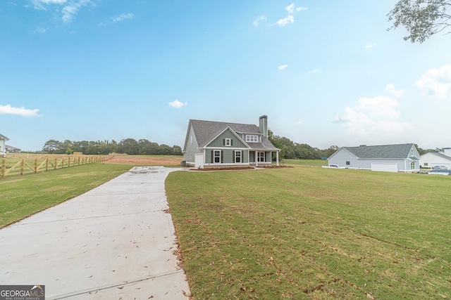 view of front of property featuring a front yard and a rural view