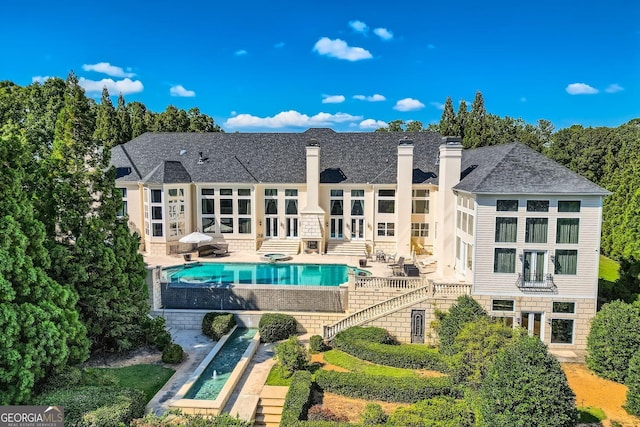 9620 Cedar Grove Rd, Fairburn, GA 30213 - rear view of property with french doors, a patio, a chimney, and an outdoor pool
