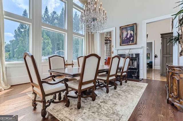 9620 Cedar Grove Rd, Fairburn, GA 30213 - dining area featuring a chandelier, a high ceiling, dark wood-style floors, and baseboards