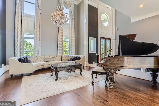9620 Cedar Grove Rd, Fairburn, GA 30213 - living area featuring crown molding, a chandelier, wood finished floors, recessed lighting, and a high ceiling