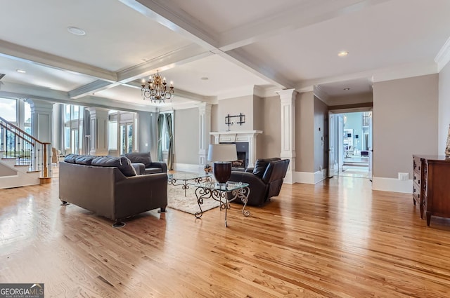 9620 Cedar Grove Rd, Fairburn, GA 30213 - living room with decorative columns, light wood-style floors, plenty of natural light, beamed ceiling, and stairway